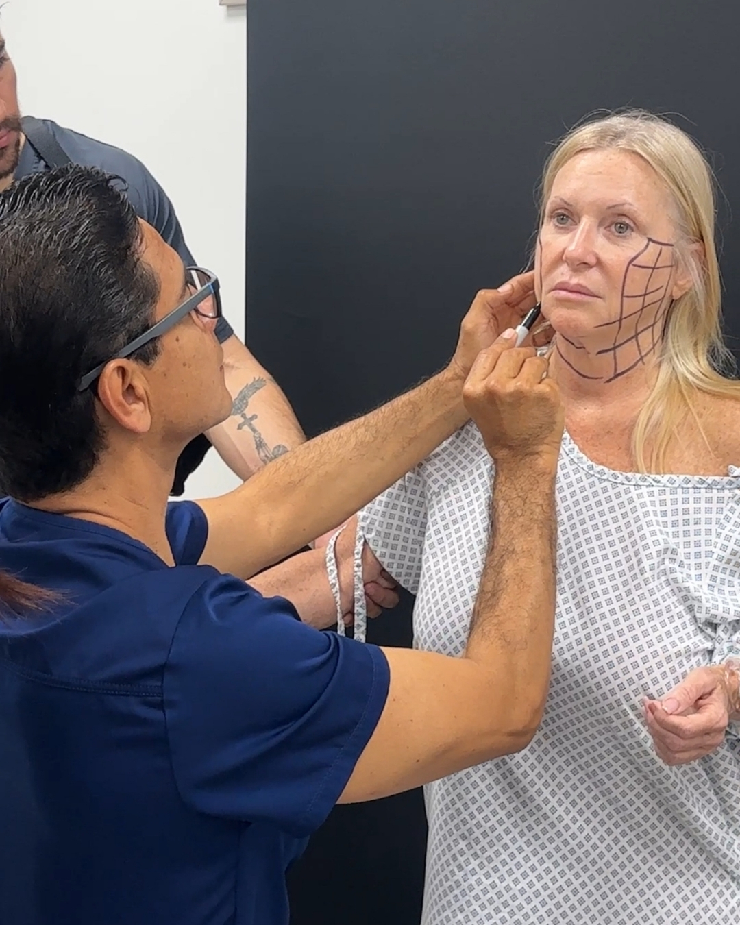 Dr. Suarez performing facial marking on a patient before a face lift procedure.